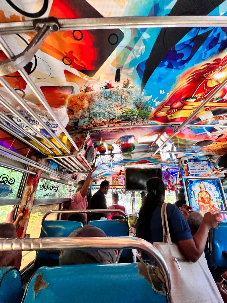 Colorful interior of a public bus in Sri Lanka crowded with local passengers.