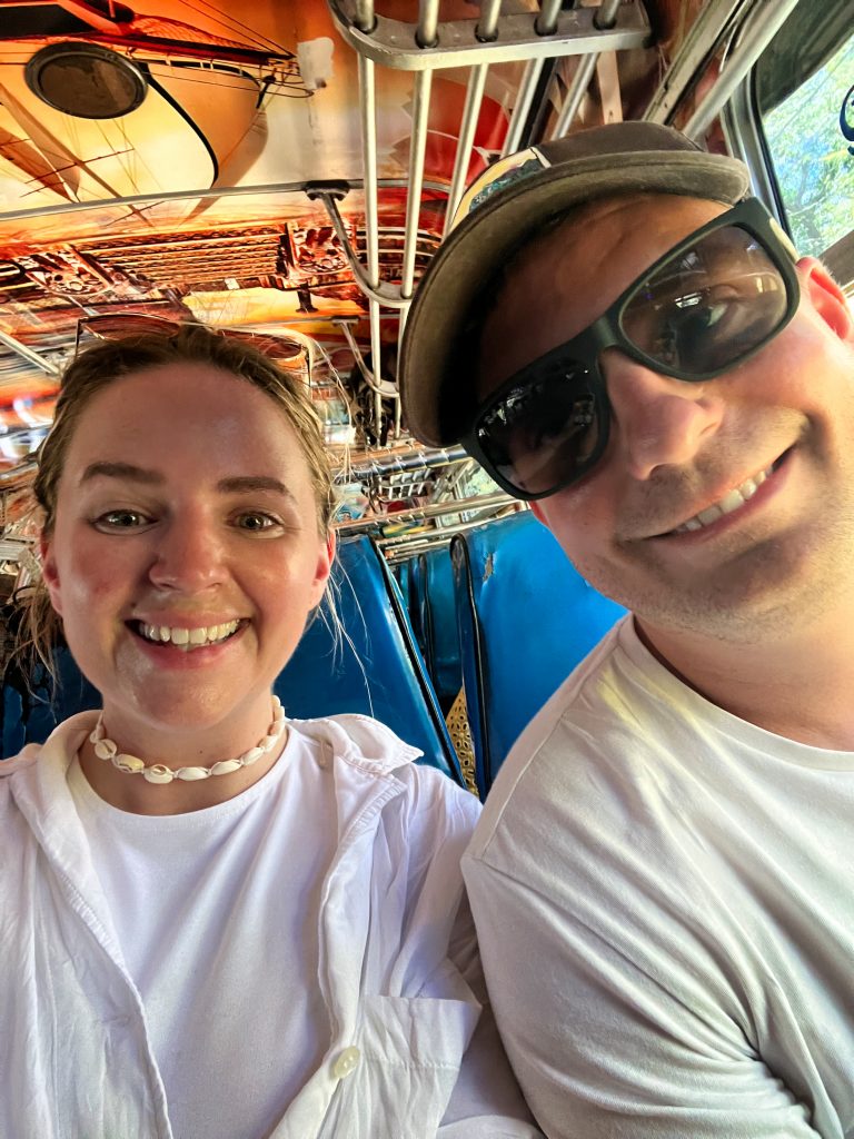 Travel couple taking a selfie on a public bus in Sri Lanka.