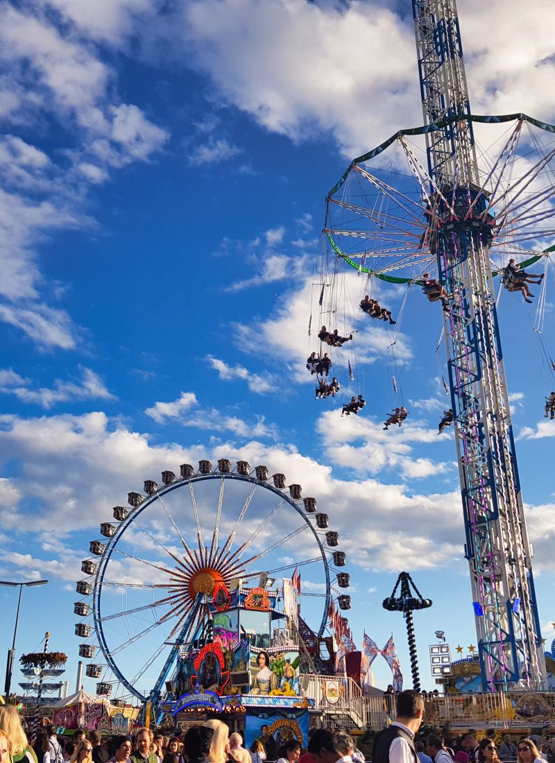 Colorful view of Oktoberfest in Munich with the Ferris wheel, beer tents, and festival crowds – Oktoberfest Munich Where to Stay guide cover image.