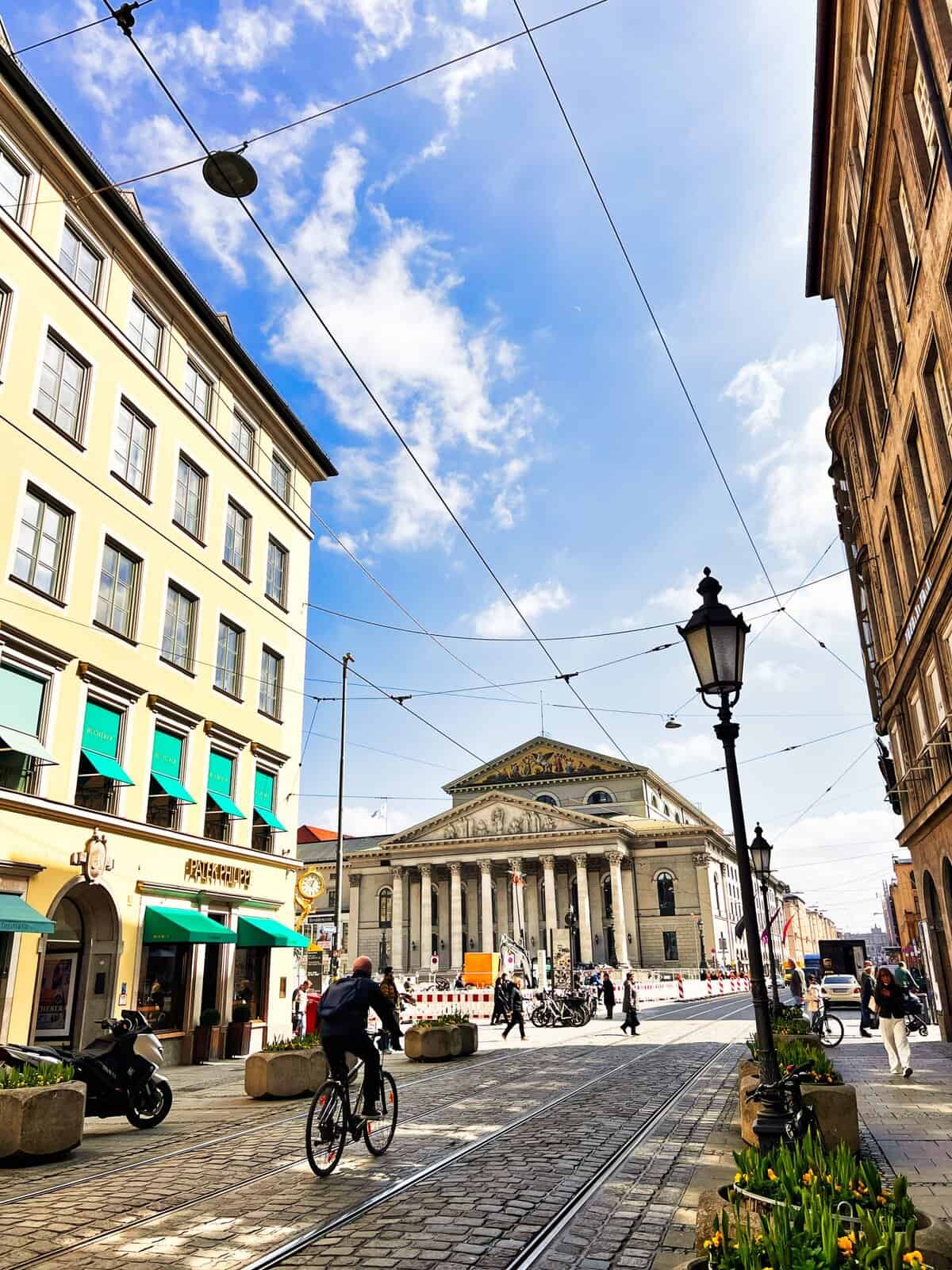 Sunny day in Munich’s city center with people strolling.