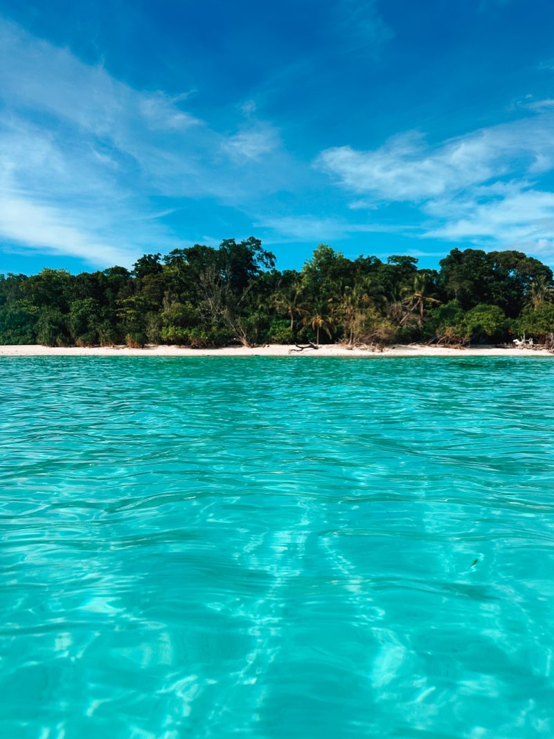 Mantigue Island photgraphed from the turquise waters. Lush trees are visible which gives shade on bright days. One of the best places to visit on Camiguin.