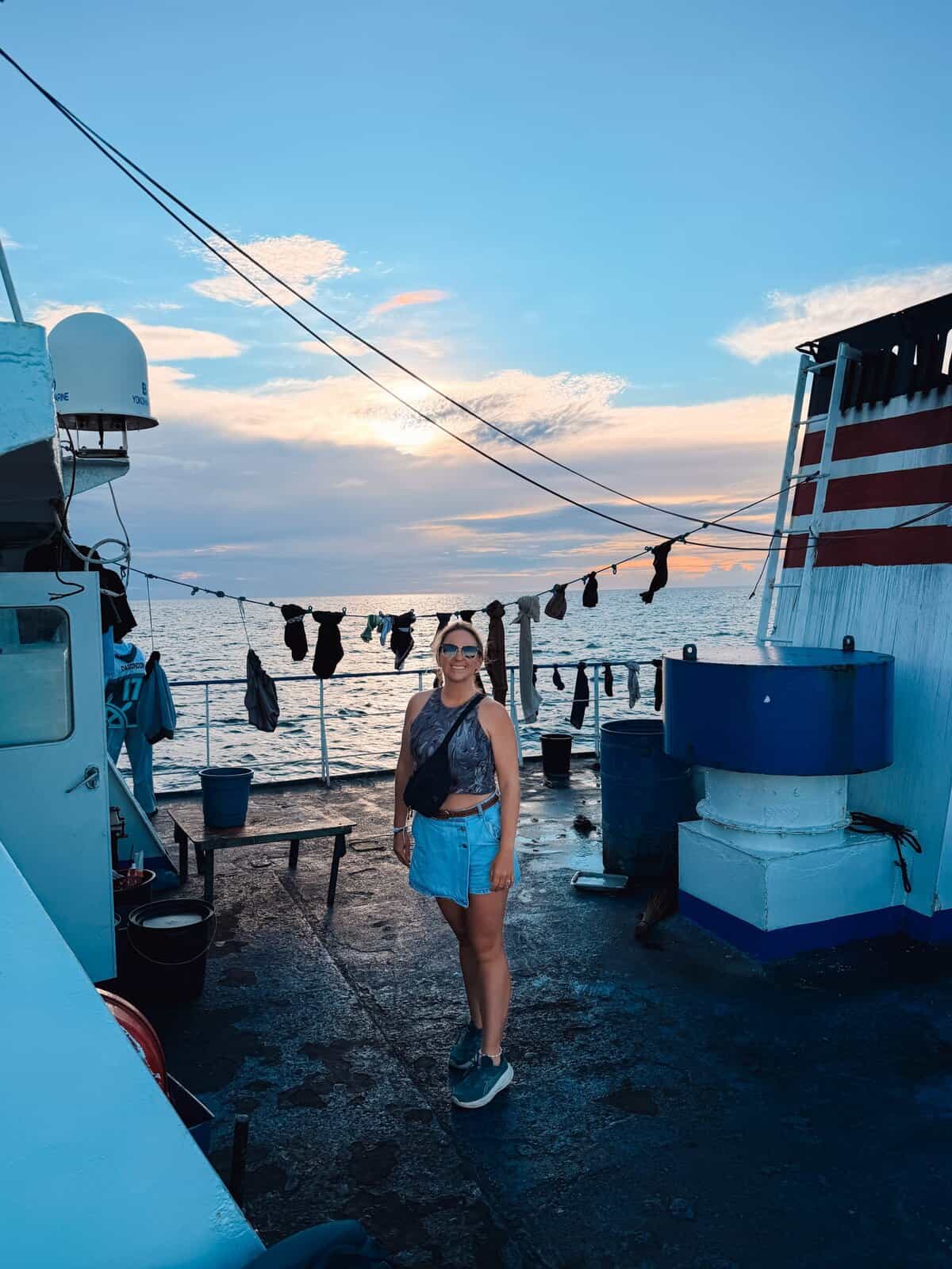 Girl smiling on the deck of a boat in the Philippines, on the way to Camiguin Island, shortly before sunset.