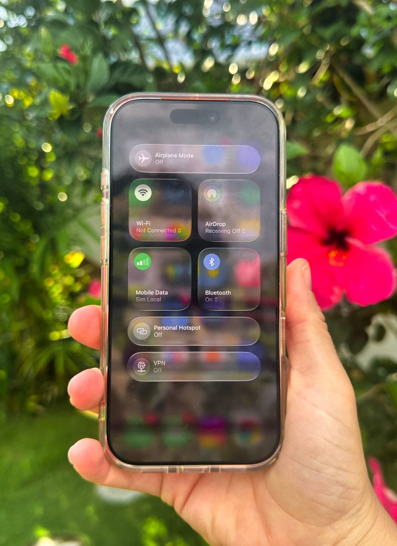 Best eSim for Asia - Sim Local. showing on my phone under Mobile Network in the Philippines in lush background.