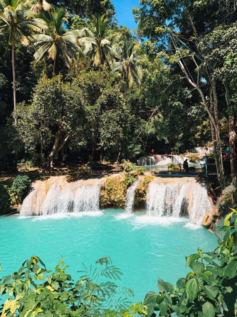 Multi-tiered turquoise waterfalls at Cambugahay Falls, Siquijor, just 35 minutes from San Juan, perfect for day trips from the recommended base.