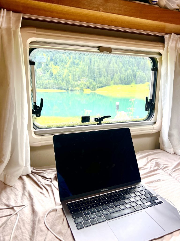 Author working on Stay22 blog setup from van in Austria – Digital nomad travel blogger