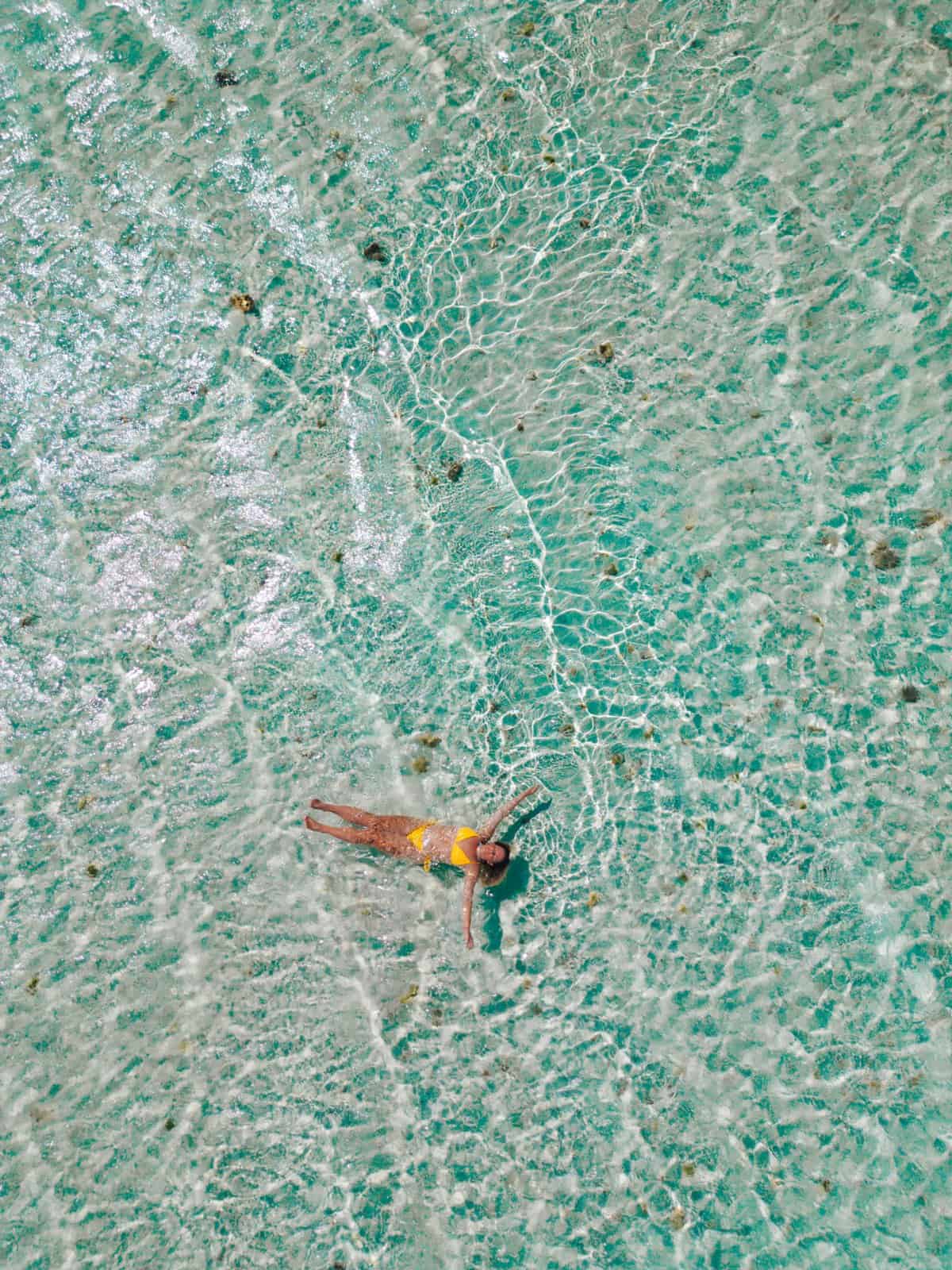 Aerial drone photograph of Camiguin Island Philippines showing turquoise shallow waters, coral reefs and white sand beaches – Featured in monetized travel guide using Stay22 affiliate booking links