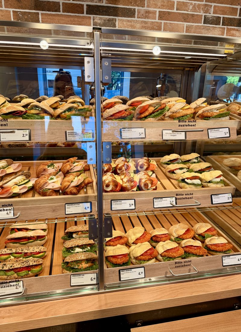 Selection of freshly made sandwiches, croissants, and healthy lunch options at a bakery café in Salzburg.