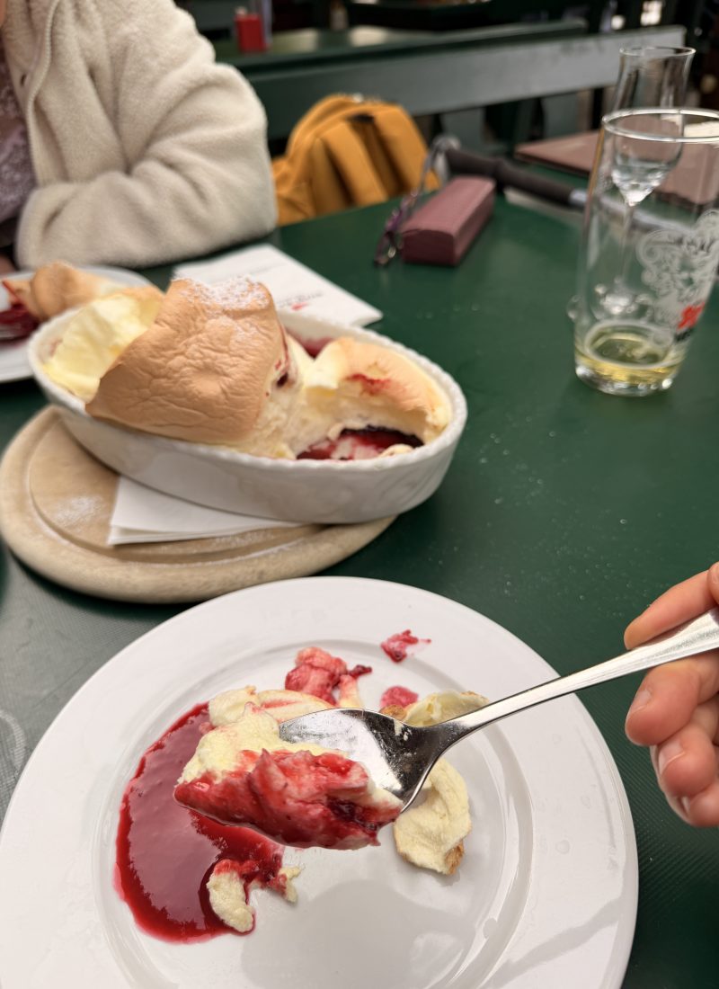 Traditional Salzburger Nockerl dessert served with berry sauce, a signature sweet specialty unique to Salzburg, Austria.