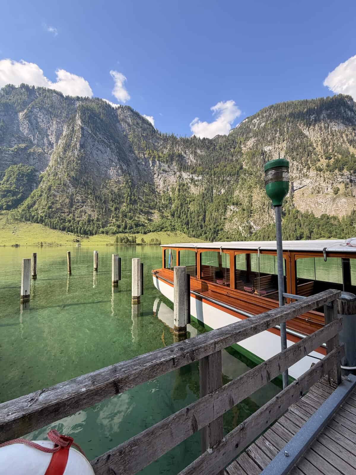 Wooden passenger boat at Salet dock on Lake Königssee surrounded by the Berchtesgaden Alps