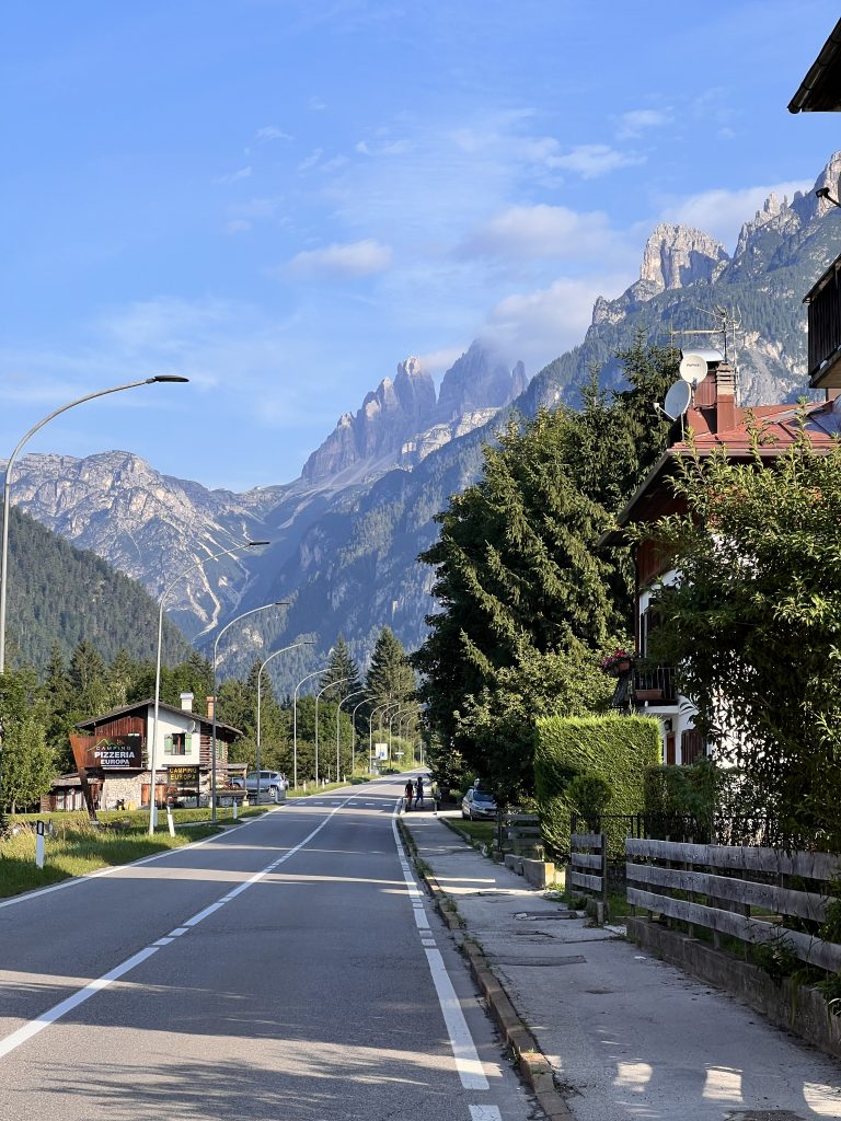 Street in Auronzo di Cadore with dramatic Dolomite mountain peaks in the background