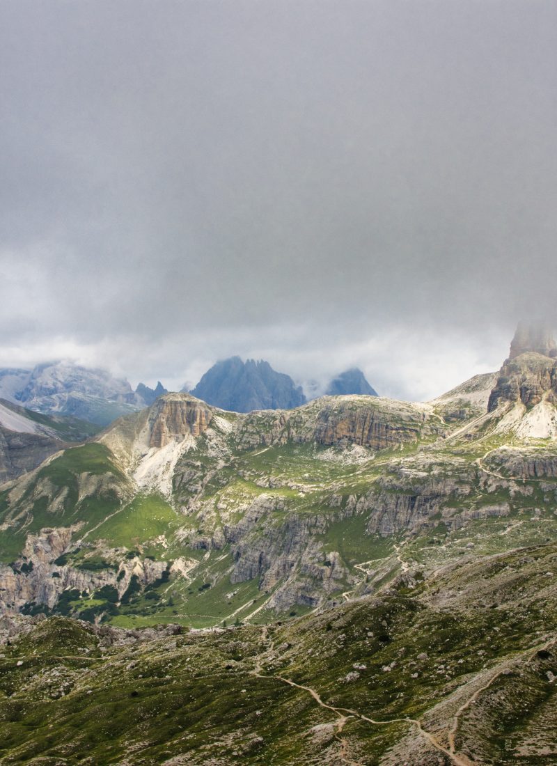 Cloud-covered mountain peaks, hiking trails and a remote refuge in the Dolomites, Italy