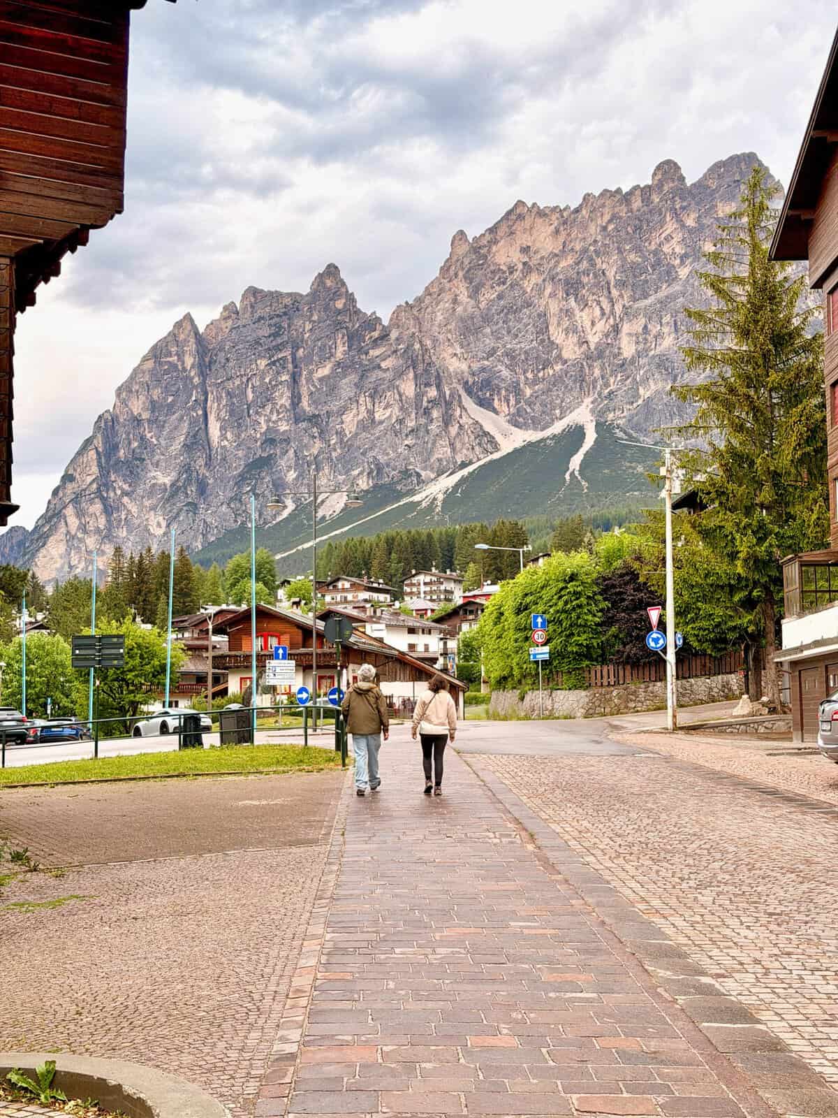 Cortina d’Ampezzo town centre beneath the dramatic Dolomite mountains, a popular place to stay in the Dolomites.